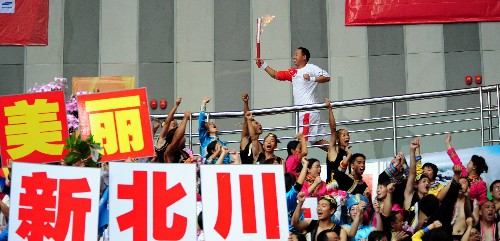 8月4日,火炬手茍義國手持火炬在展示傳遞中。當(dāng)日,北京奧運圣火在四川省綿陽市九洲體育館展示傳遞。 新華社記者劉力航攝